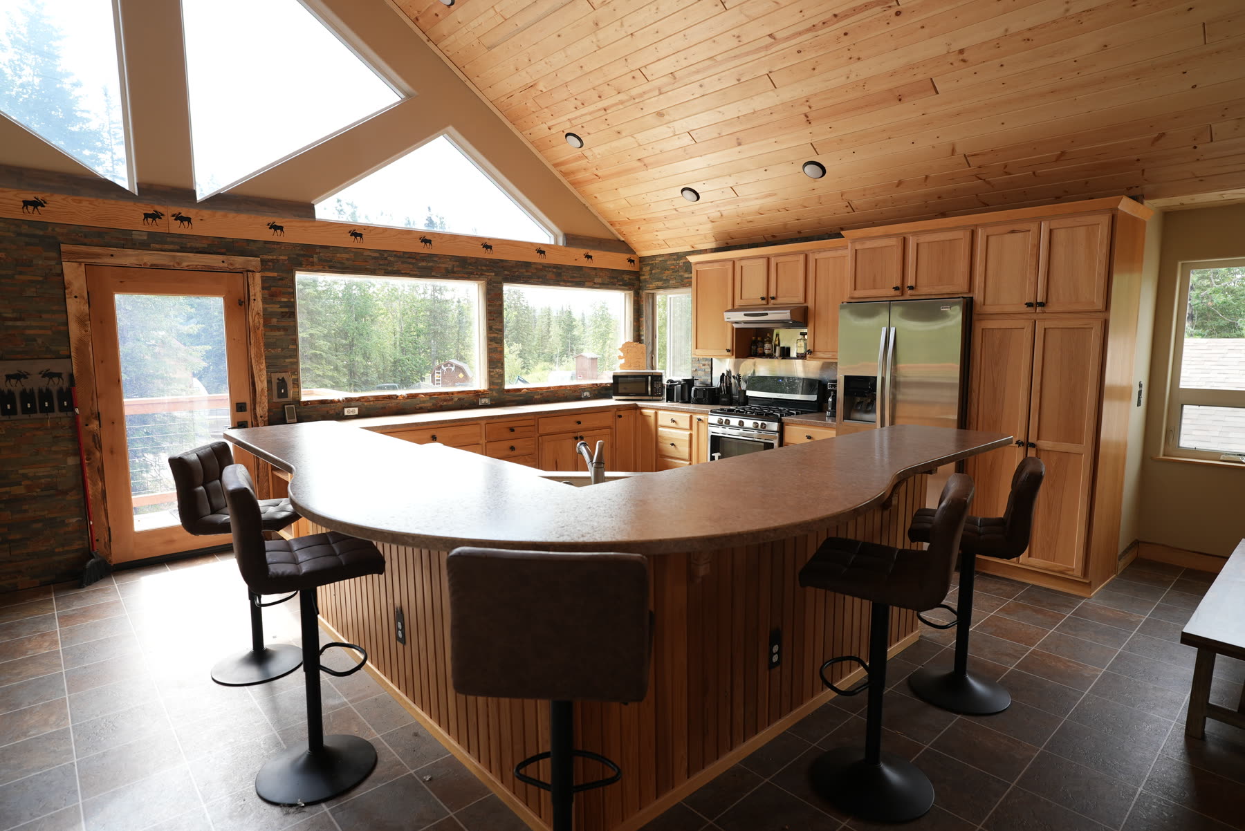 Kitchen island with bar seating under a vaulted ceiling